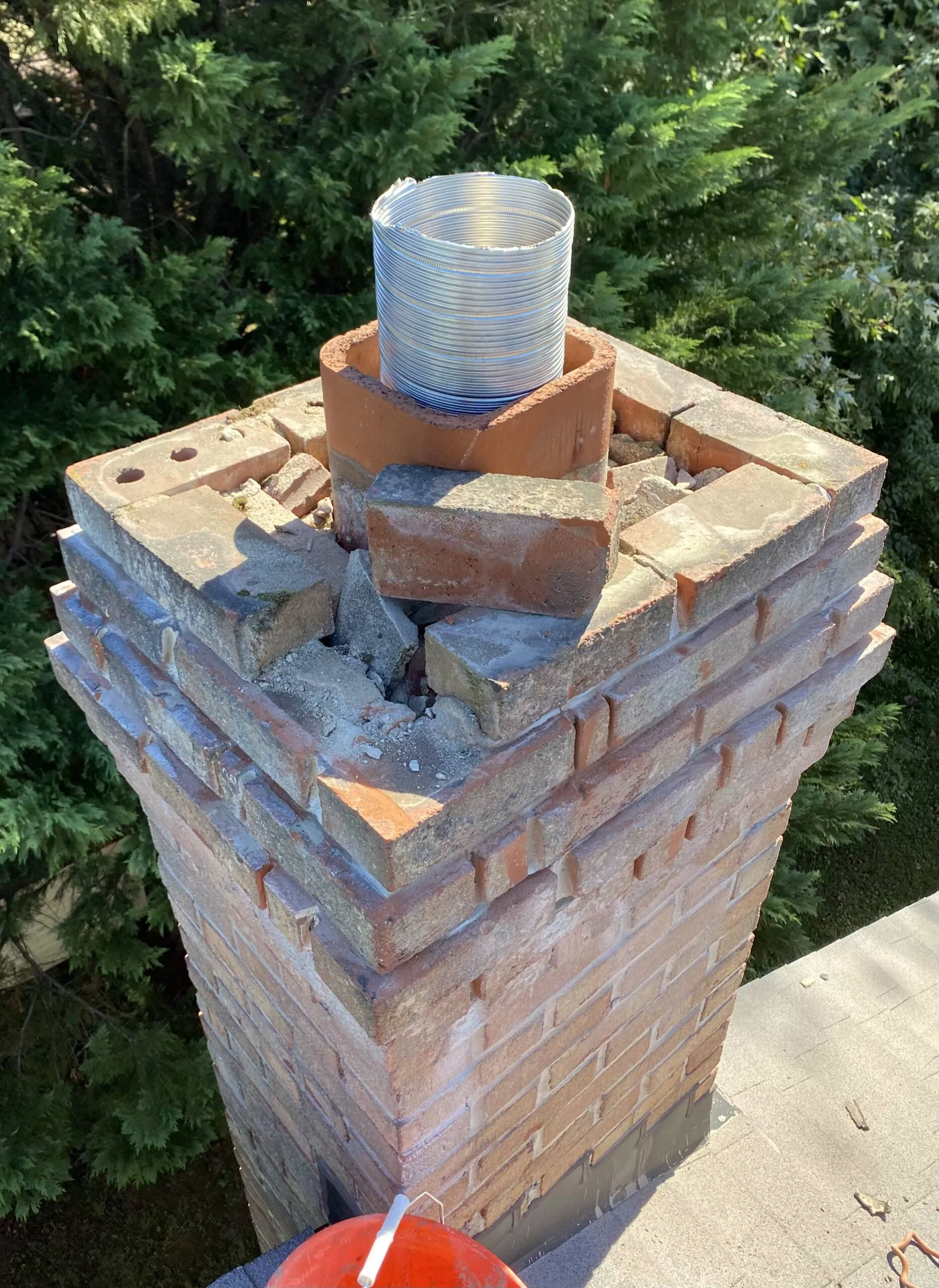 Damaged chimney crown requiring professional repair